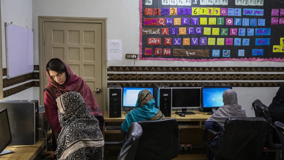 A refugiada afegã Nadia Hamidi (à esquerda) participa de sua aula de informática no Safe from the Start, uma iniciativa apoiada pelo ACNUR nos arredores de Quetta