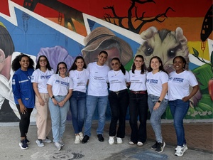 Grupo de personas hombres y mujeres jóvenes con camisetas de ACNUR y PWC
