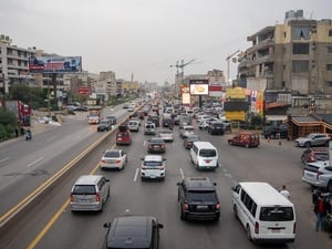 Vista de lo alto de una carretera atestada de vehículos que se dirigen hacia la misma dirección.