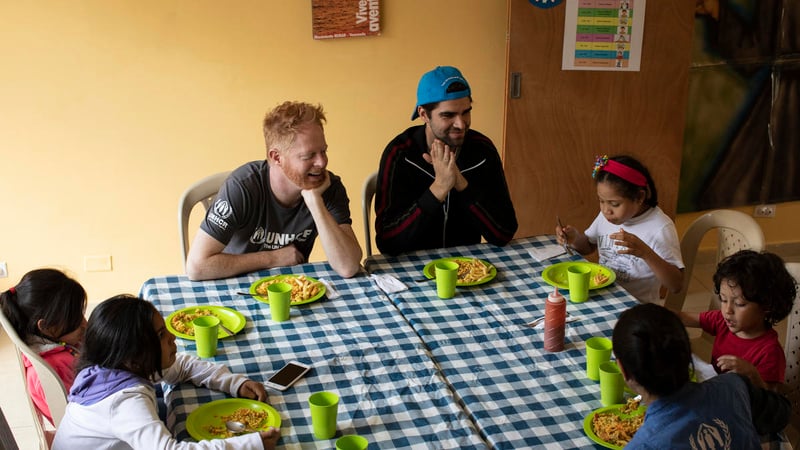 Colombia. UNHCR supporter Jesse Tyler Ferguson (centre) and his husband Justin Mikita (centre-right) spend time with Venezuelan refugee and migrant children