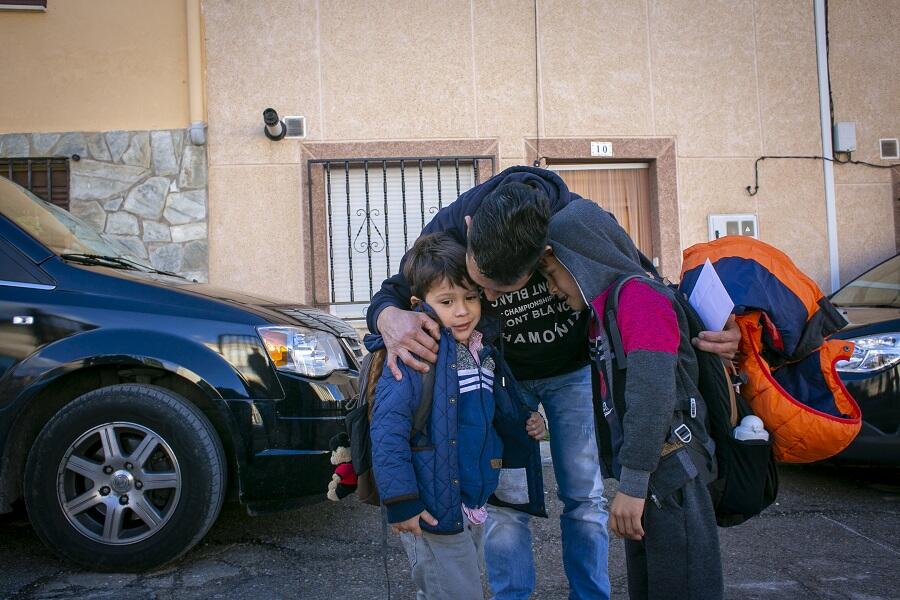 Ángel Márquez abraza a sus dos hijos, Santi (4 años) y Sebas (6 años) a la salida del colegio en Pareja, Guadalajara.
