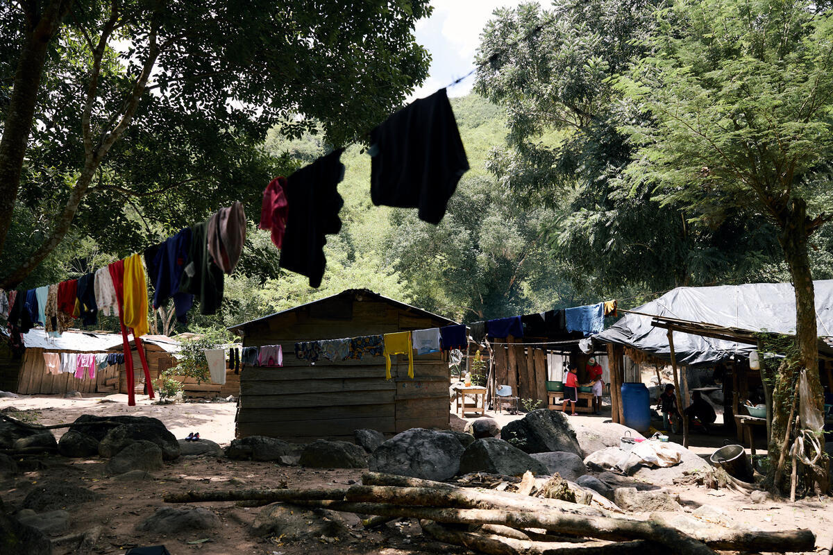 La ropa colgada en tendederos detrás de cabañas de madera en un claro del bosque