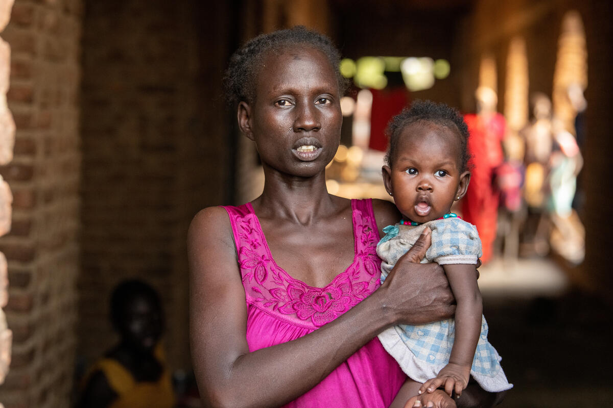 Mary, an internally displaced person, poses for a photo with her daughter at an IDP site in Malakal, South Sudan.