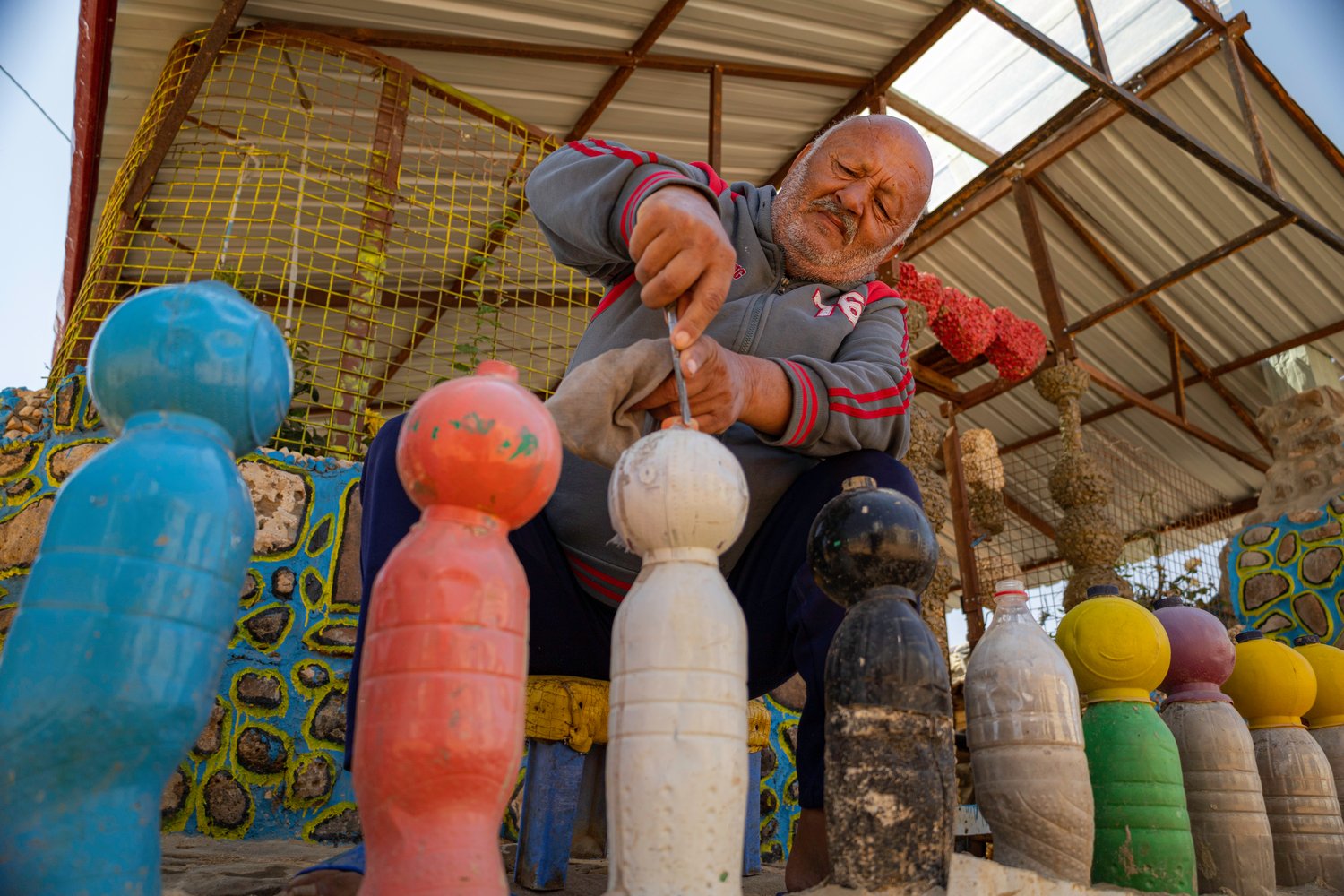Abu Jihad working on bollards made from plastic bottles. 