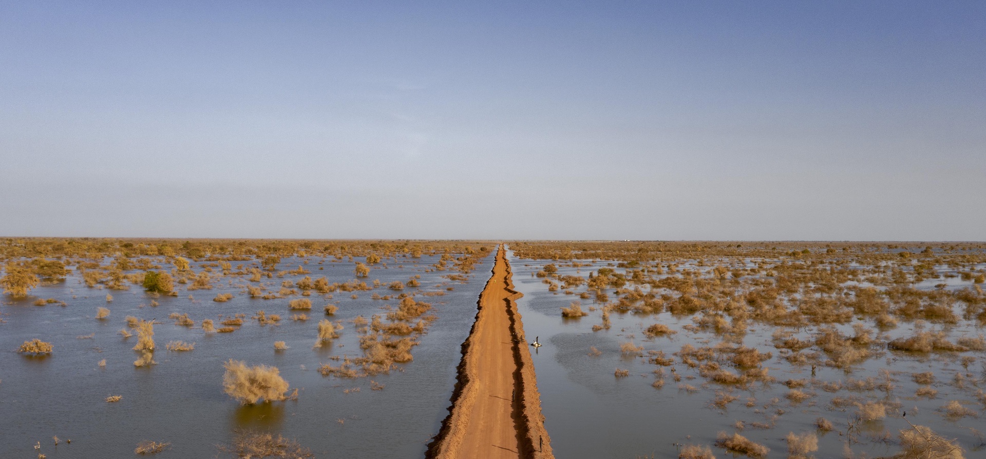 Una carretera atraviesa aguas que se extienden hasta el horizonte.