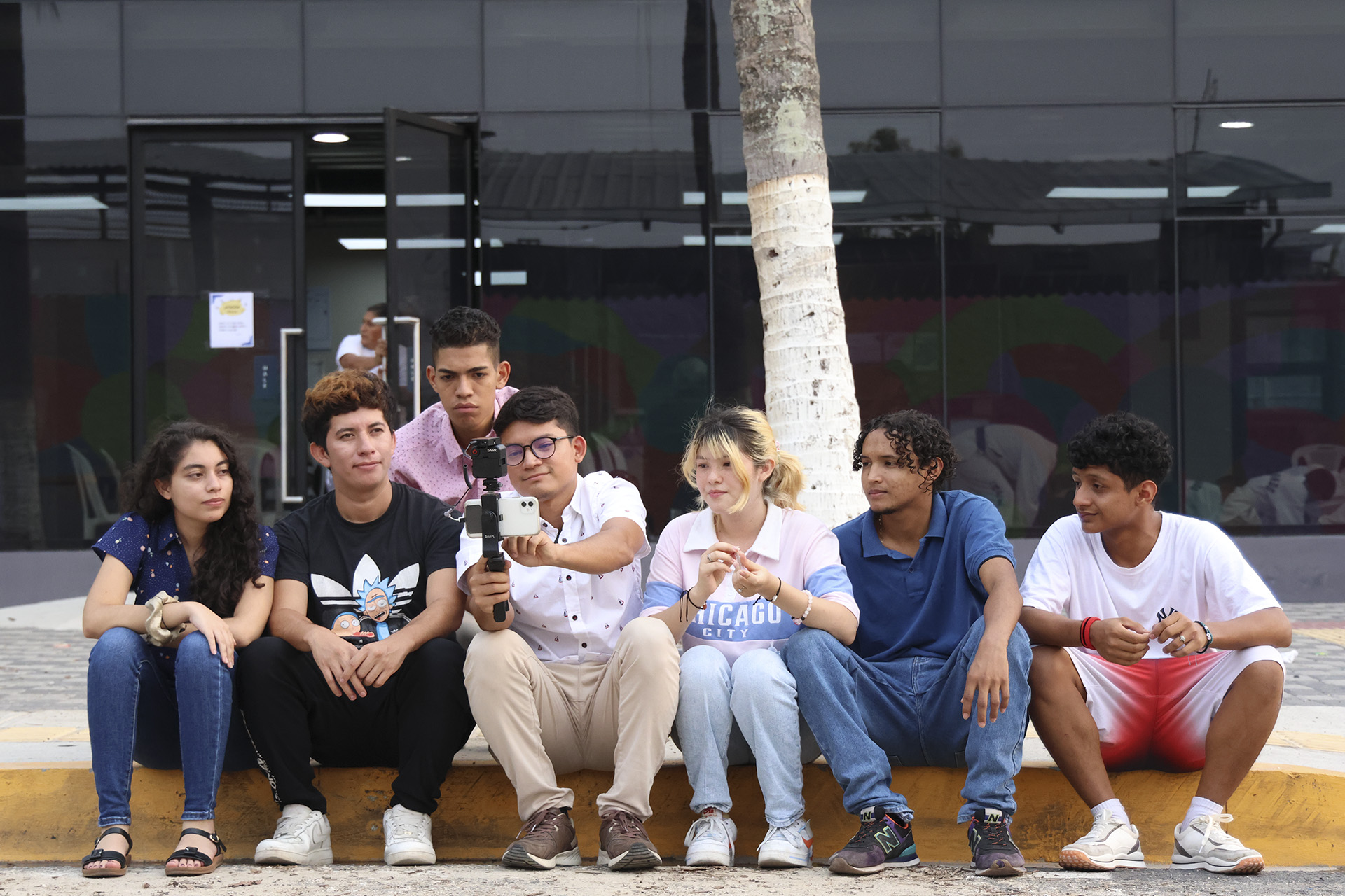 Guillén (de camisa blanca al centro) y otros jóvenes producen videos para invitar a los vecinos y vecinas de su comunidad a participar en las actividades que realizan.