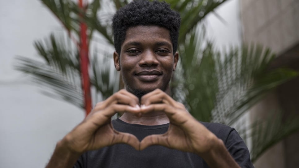 Un joven de Côte d’Ivoire hace un corazón con las manos Un joven de C