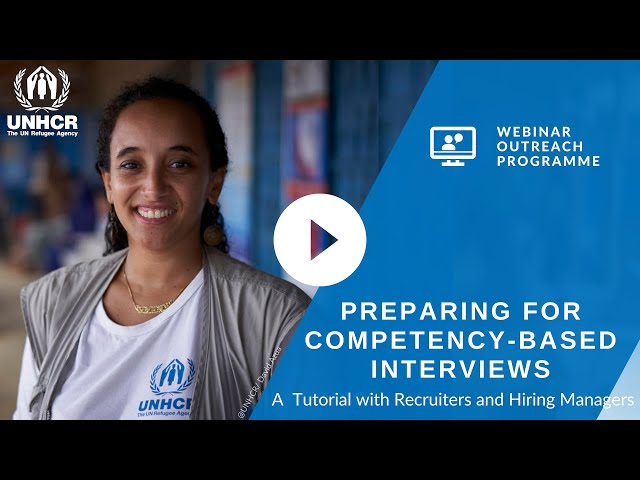 A UNHCR staff member smiling at the camera