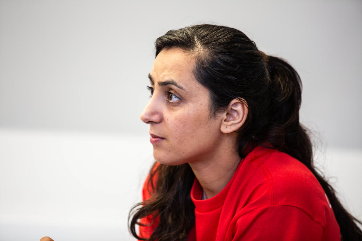 El perfil de una mujer de cabello negro que viste ropa roja