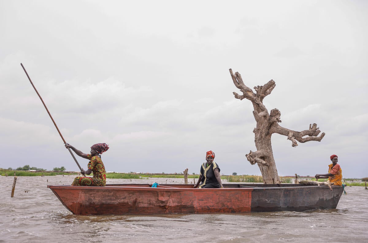 Nyepuka Chan, 45, Nyeboth Tut, 38, and Nyegai Kulang , 40, who were displaced due to flooding collect Lilly for lunch for their family in Bentiu, South Sudan.