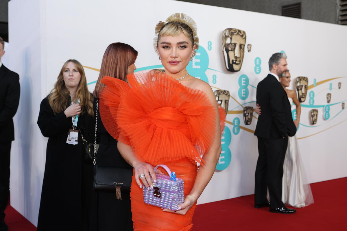 United Kingdom. Actor Florence Pugh wearing a blue ribbon in solidarity with refugees at the EE BAFTA Film Awards 2023
