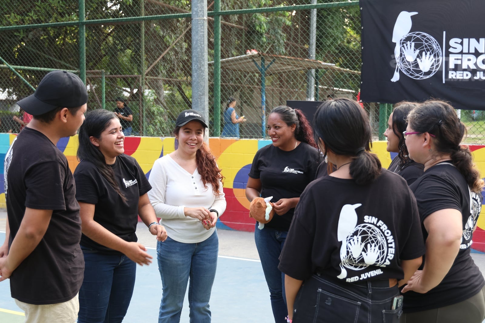 Un grupo de jóvenes conversando en círculo.