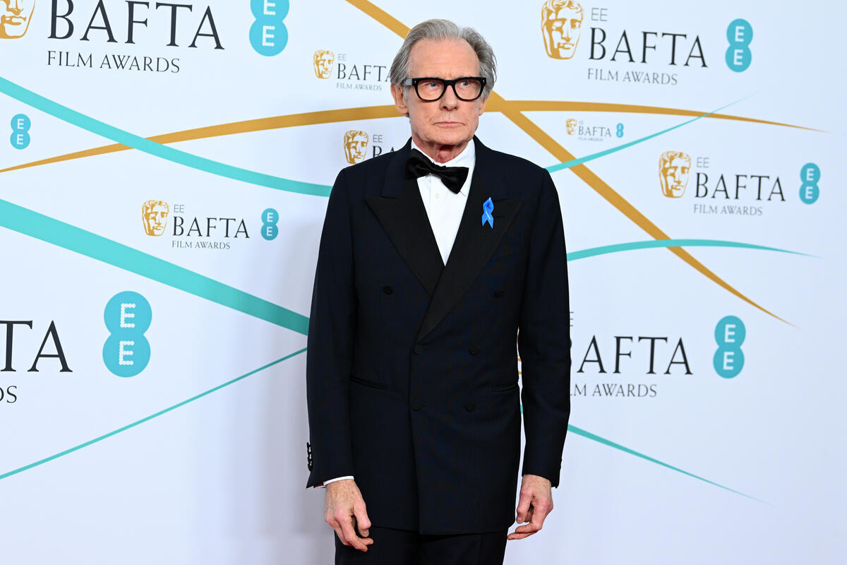 United Kingdom. Actor Bill Nighy wears a blue ribbon in solidarity with refugees at the EE BAFTA Film Awards 2023