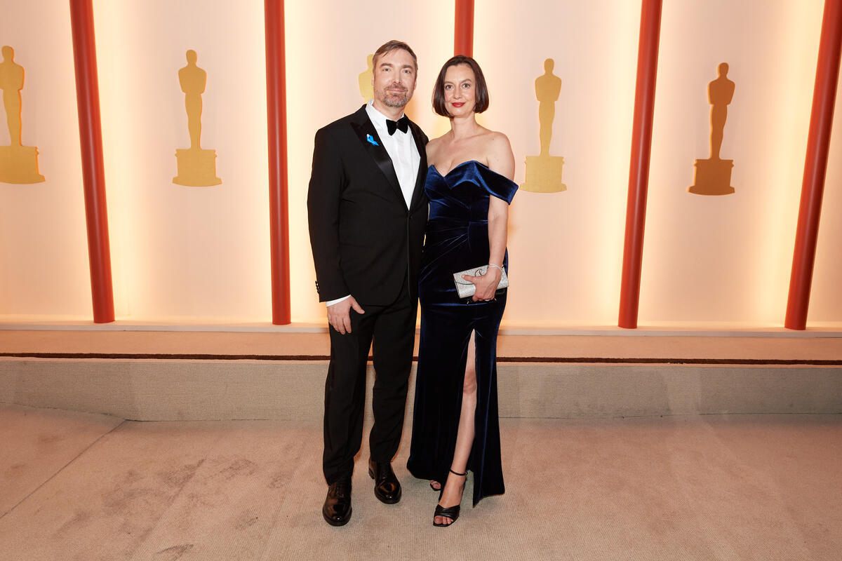 United States. Oscar nominee Viktor Müller and guest arrive on the red carpet of the 95th Oscars wearing a blue ribbon in solidarity with refugees