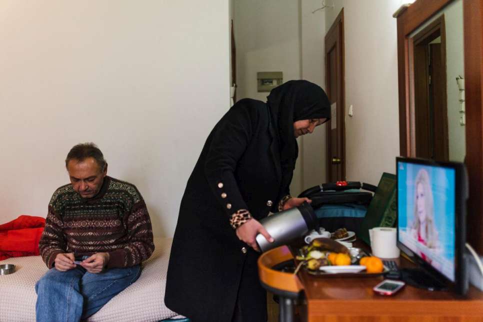 Reem Al-Hayek prepara café en una habitación de hotel donde la familia se aloja mientras espera a que su solicitud de reubicación sea aprobada.
