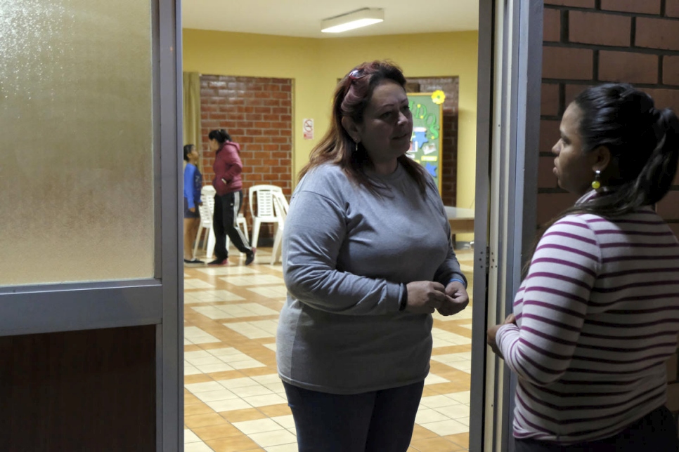 Luz Tamara Angulo (izquierda) brinda apoyo psicosocial a niños venezolanos en el albergue Scalabrini en Lima, Perú. 