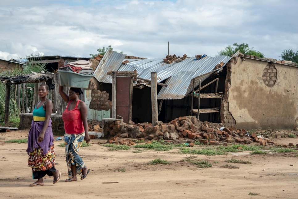 Dos mujeres pasan frente a una casa destruida durante el ciclón Idai en el campamento de refugiados de Tongogara, en el distrito de Chipinge, en el sureste de Zimbabue. 