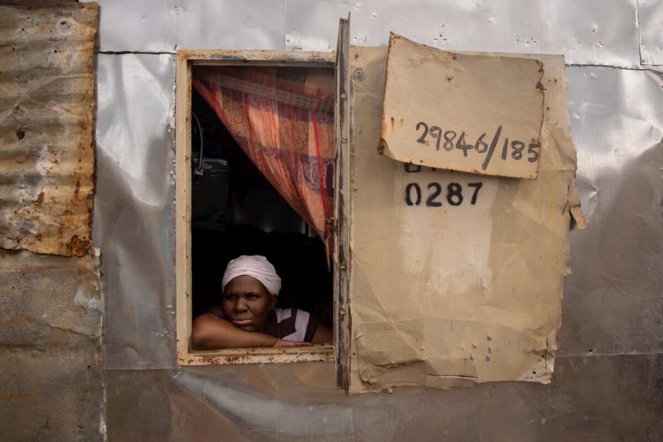 Bonisiwe mira por la ventana en la pequeña casa de lámina que comparte con tres de sus hijos en el pueblo de Mamelodi, en Pretoria, Sudáfrica.
