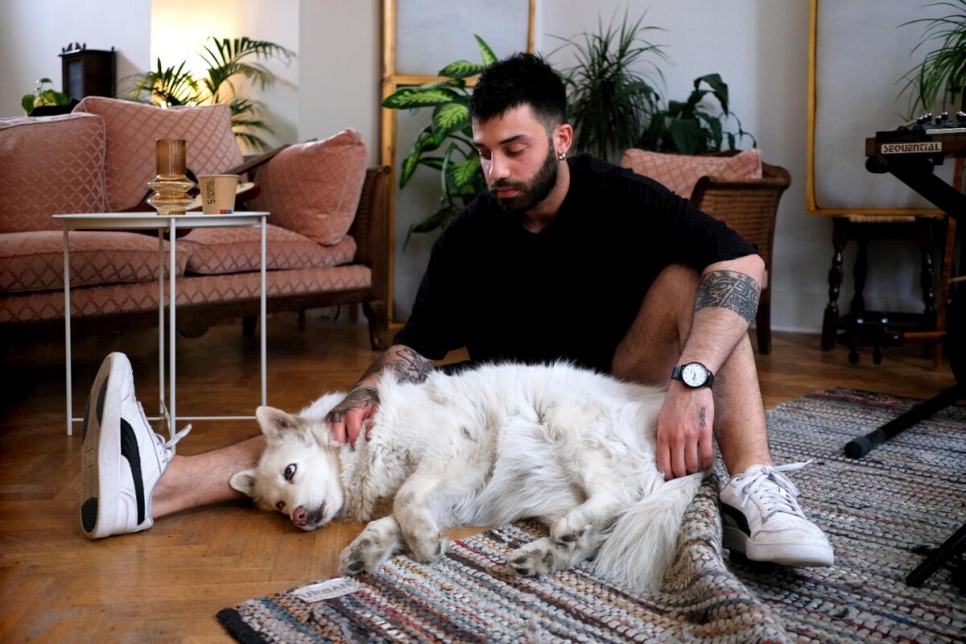 Bélgica. El refugiado sirio y músico Bassel abraza a Stella, su perra blanca de raza pastor en su nuevo hogar
