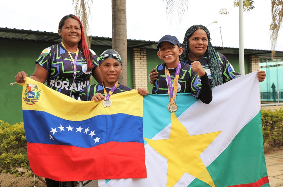 From left to right: Yusleni and his son Johnny, bronze in swimming;  and George in Athletics Gold and his mother Liliana.