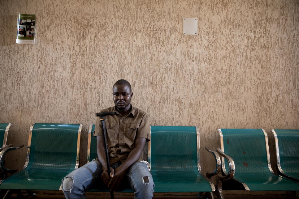 Ibrahim* sentado en la sala de espera de un centro comunitario de ACNUR en Trípoli para ver a la doctora Hanan Al-Shremi, psiquiatra.