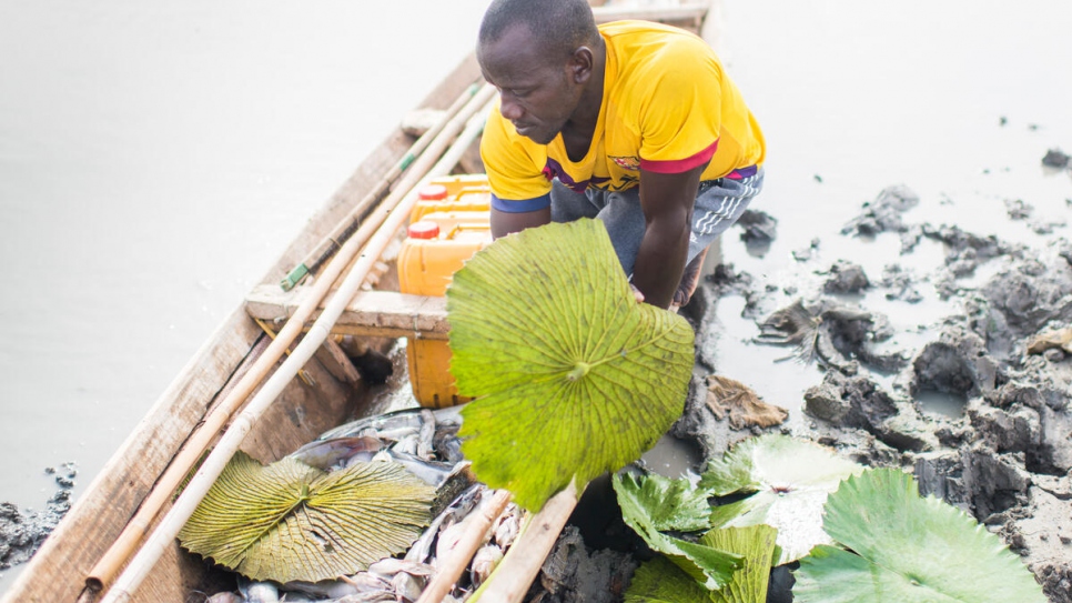 Yahya Koronio Kona, un pescador maliense, inspecciona el pescado que atrapó en el lago Mahmouda, en Mauritania.