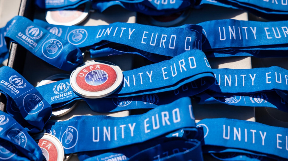 Medallas de los ganadores de la Eurocopa, con los nombres de los coorganizadores ACNUR y UEFA.