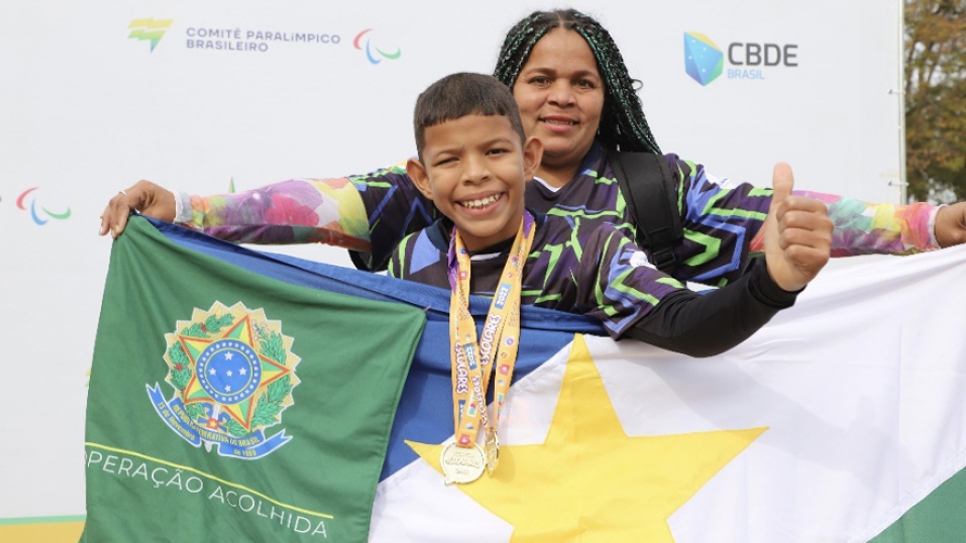 George and his mother Liliana on stage at the Regional Paralympic School Games in Brasilia.