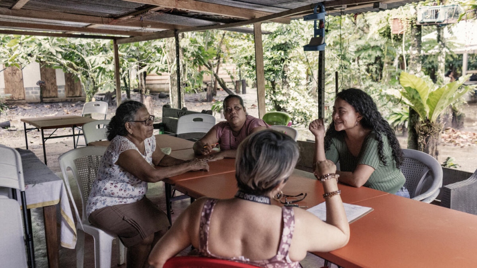 Vicenta (izquierda, con blusa blanca) y sus colaboradoras, Maricela Gutiérrez (centro) y Dara Argüello (derecha), en una reunión en la granja con una integrante de la comunidad local.